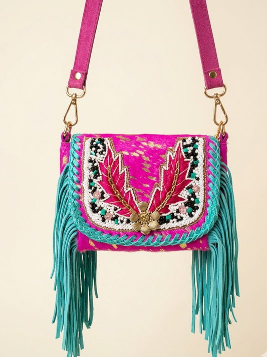 Colorful handbag with fringe and embroidery on a beige background