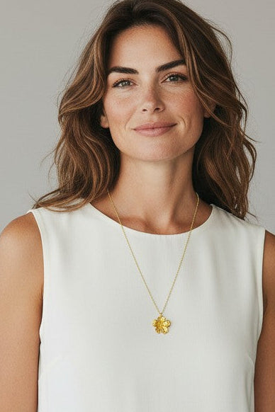 Woman wearing a white sleeveless dress against a plain background