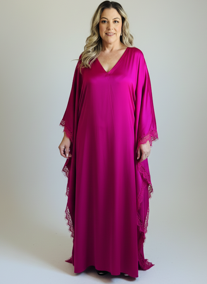 Woman wearing a pink long dress with lace sleeves on a white background