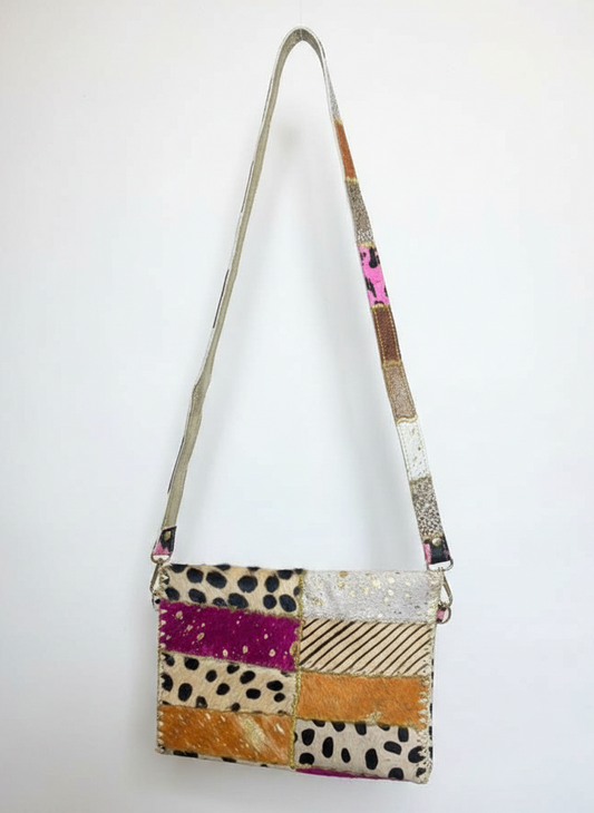 Patchwork-style handbag with multicolor pattern on a white background