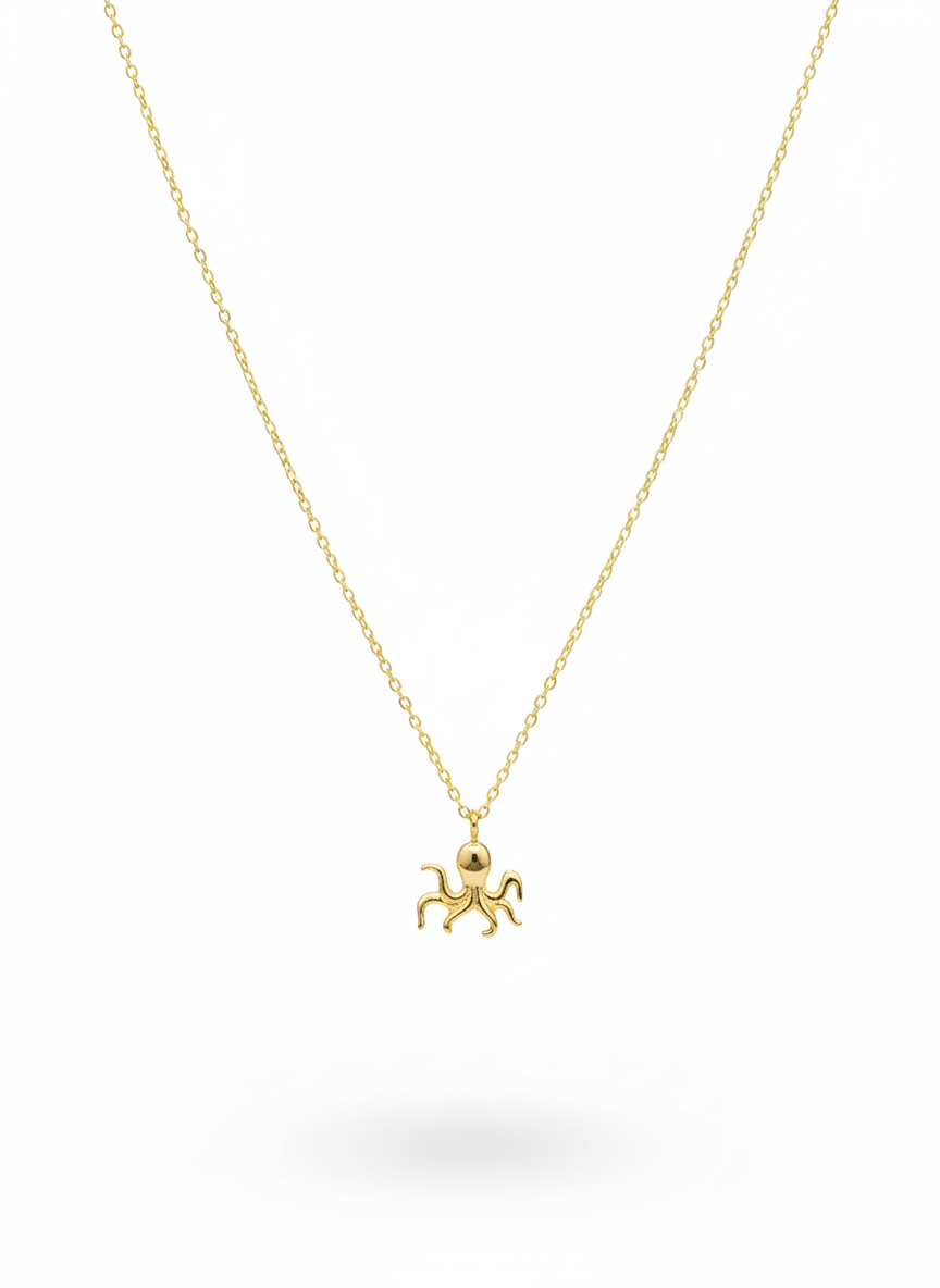 Gold octopus pendant necklace on a white background