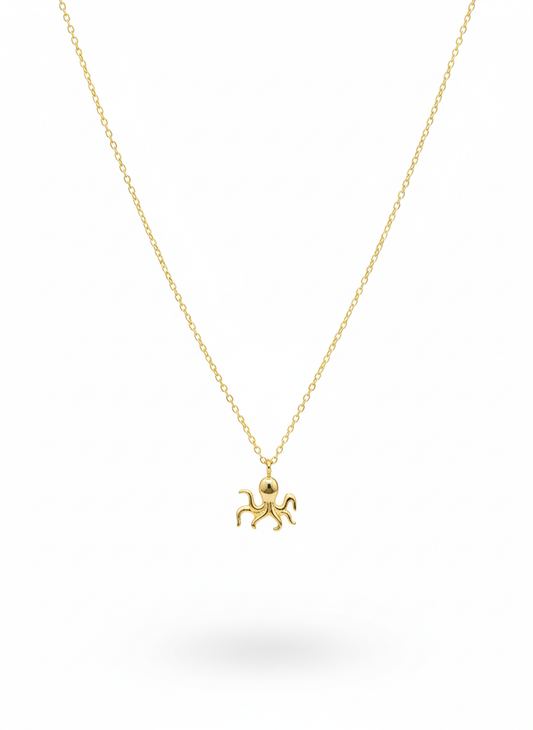 Gold octopus pendant necklace on a white background