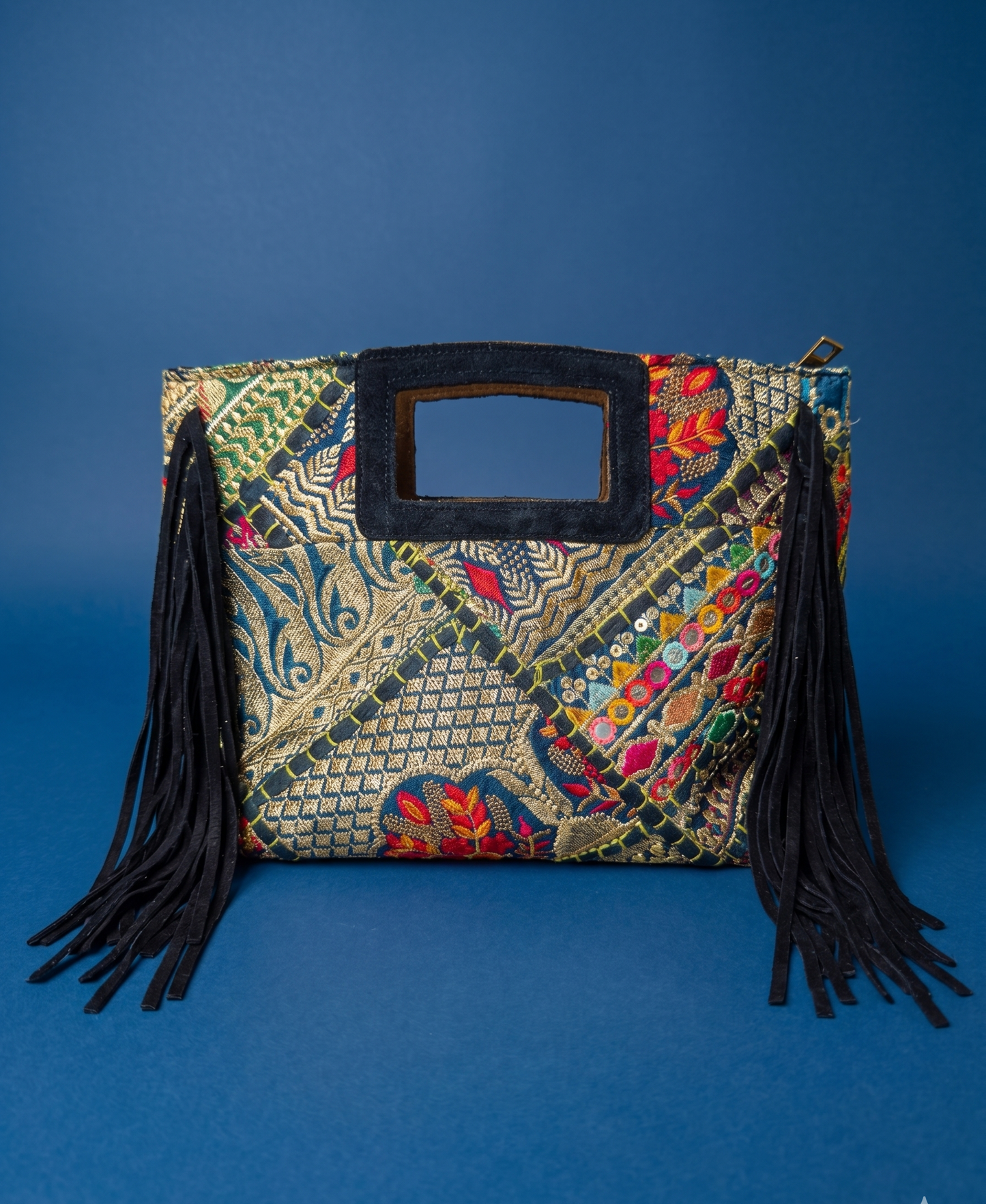 Embroidered handbag with tassels on a blue background