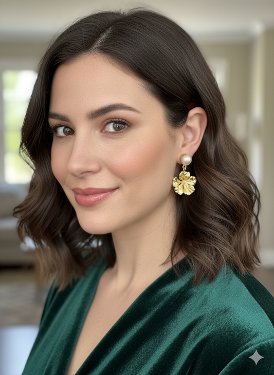 Woman wearing gold earrings with a blurred indoor background