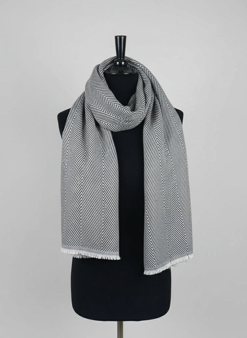Mannequin wearing a black and white patterned scarf against a neutral background