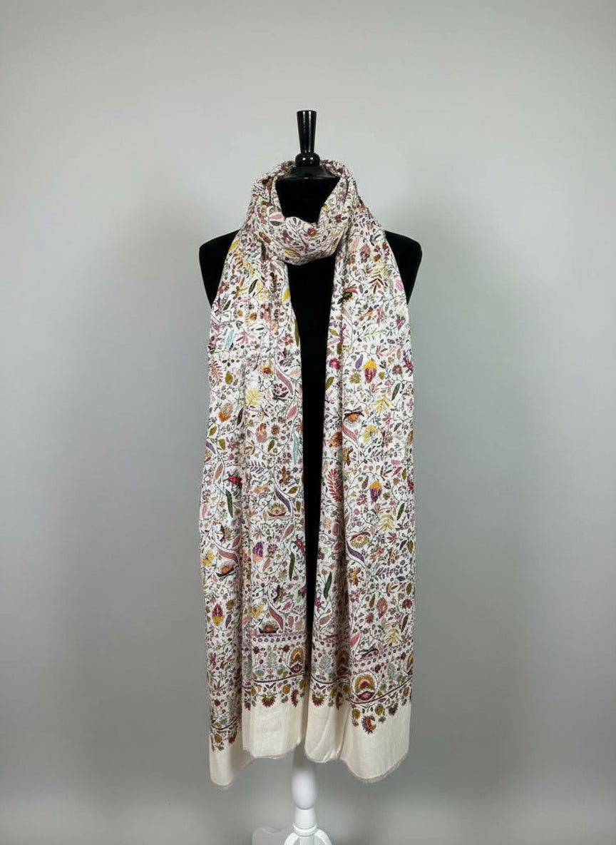 Patterned scarf on a mannequin against a neutral background
