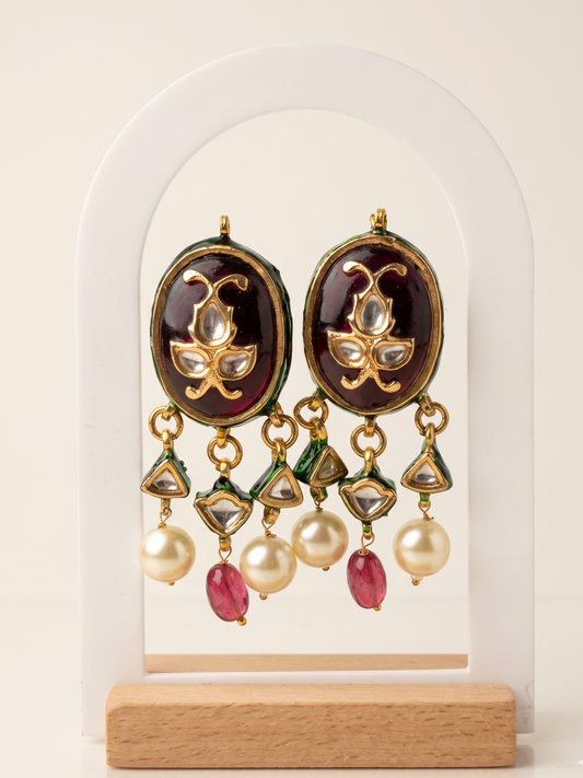 Ornate earrings with gemstones on a white background
