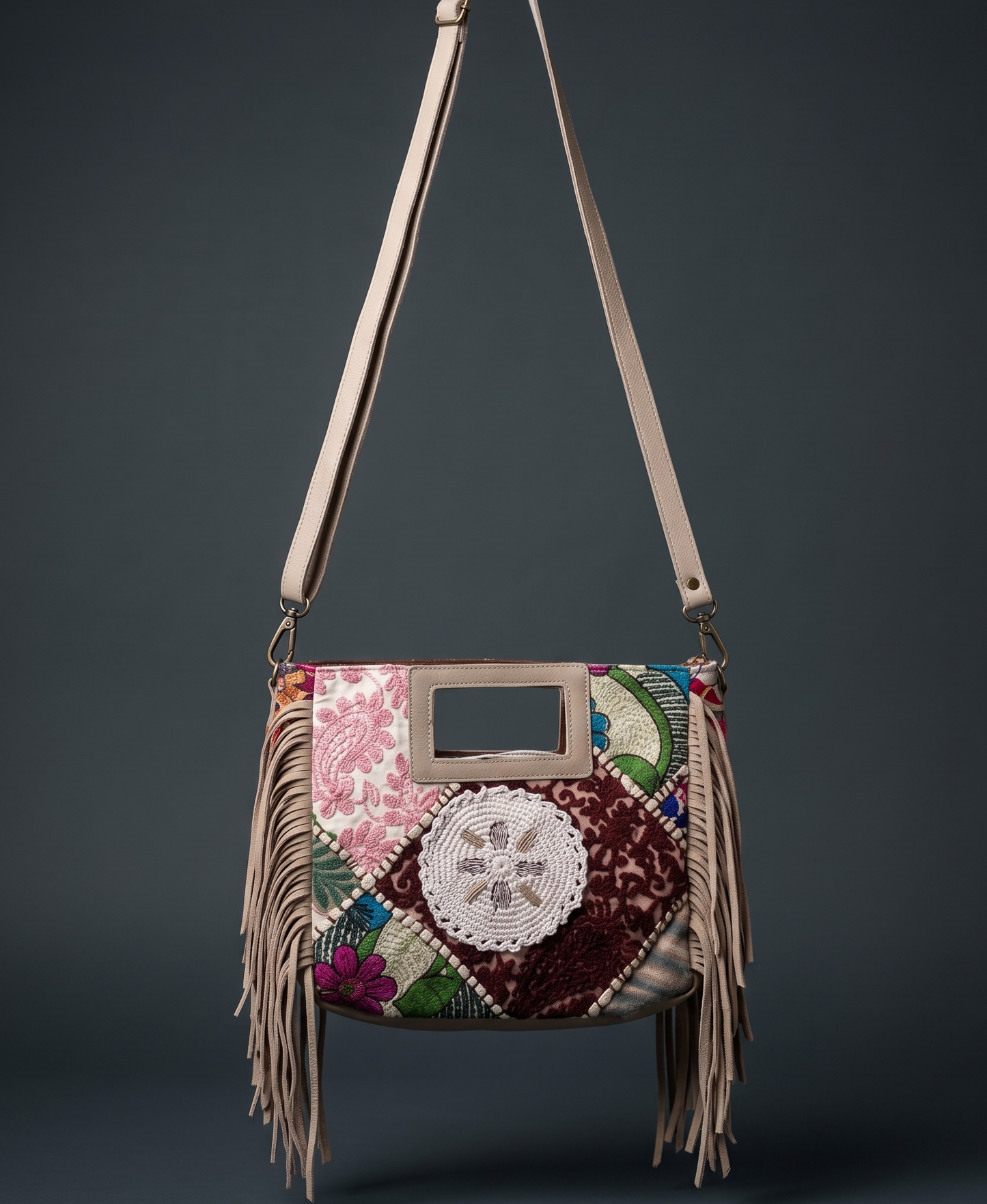 Multicolored handbag with floral patterns and fringes on a dark background