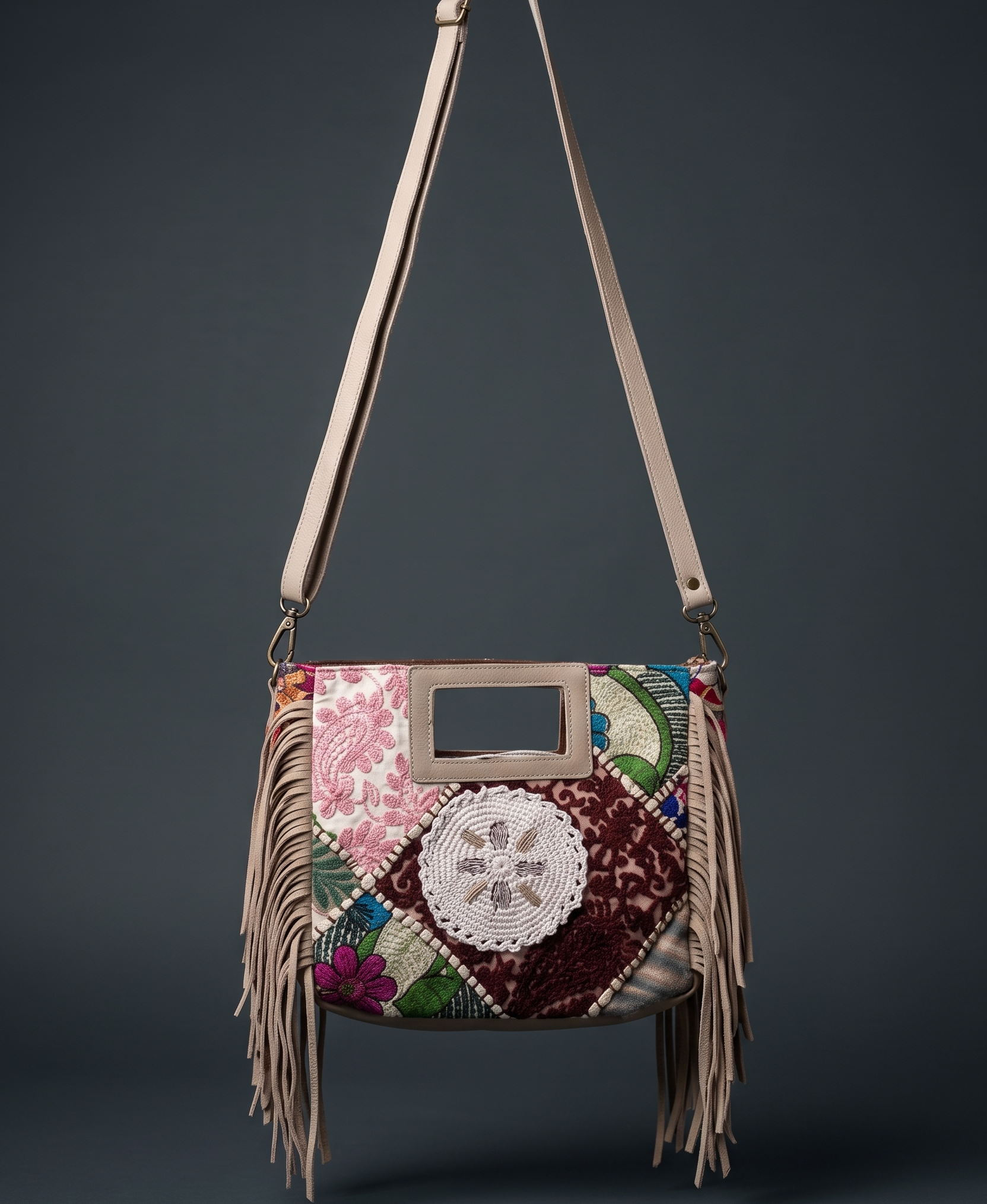 Multicolored handbag with floral patterns and fringes on a dark background