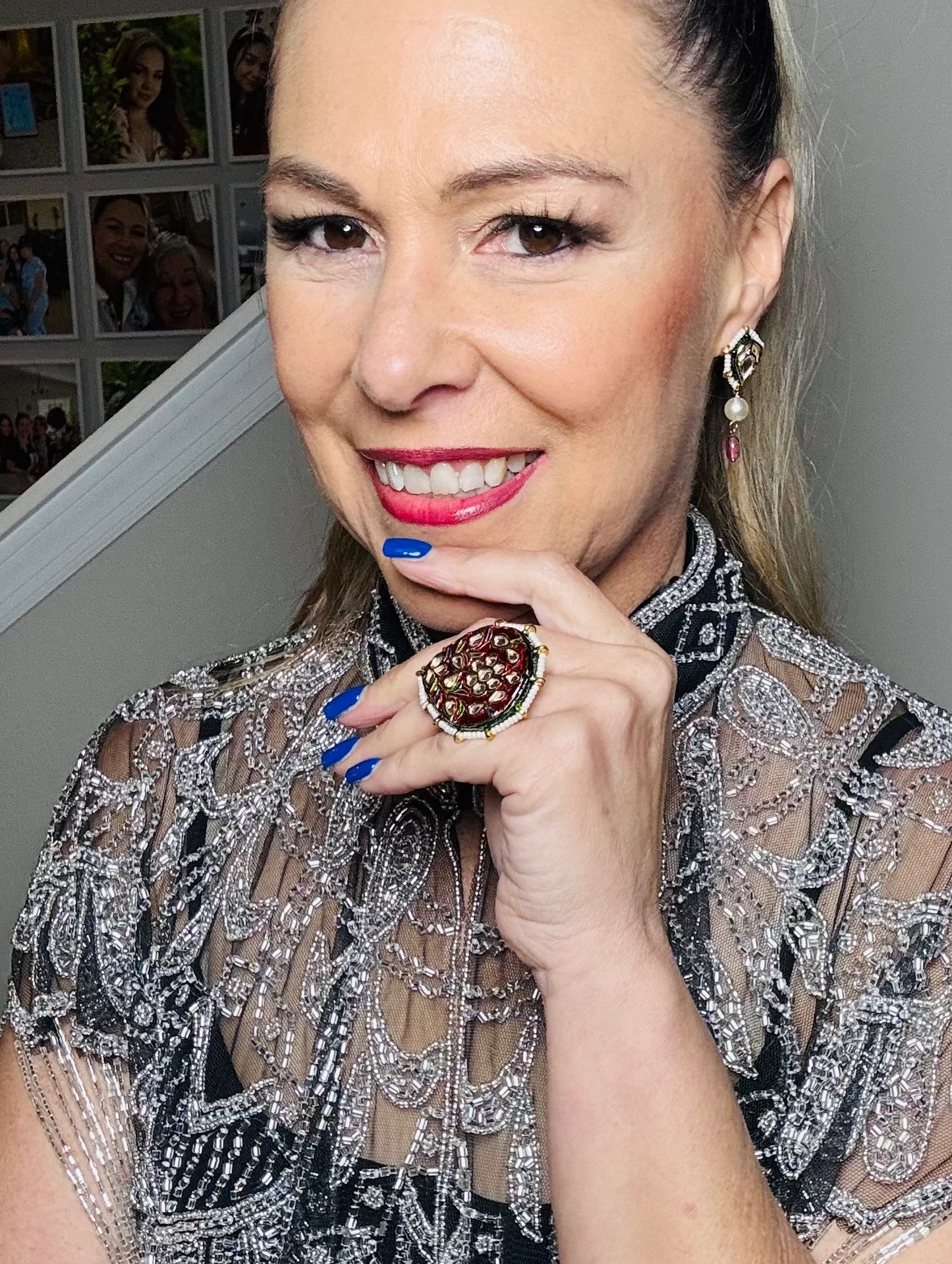 Woman wearing a decorative ring indoors with a neutral background
