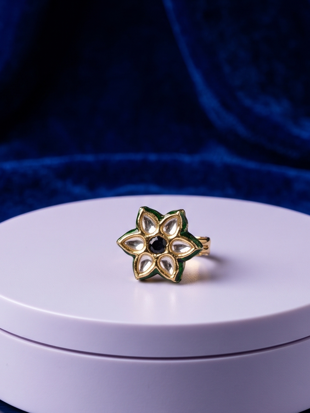 Elegant handcrafted Kundan ring featuring a deep black center stone, floral crystal-inspired detailing, and radiant 22Kt gold plating designed for timeless sophistication.