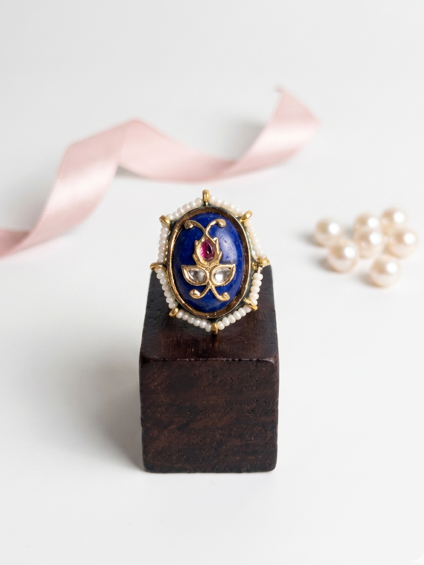 Decorative ring on a wooden stand with a white background