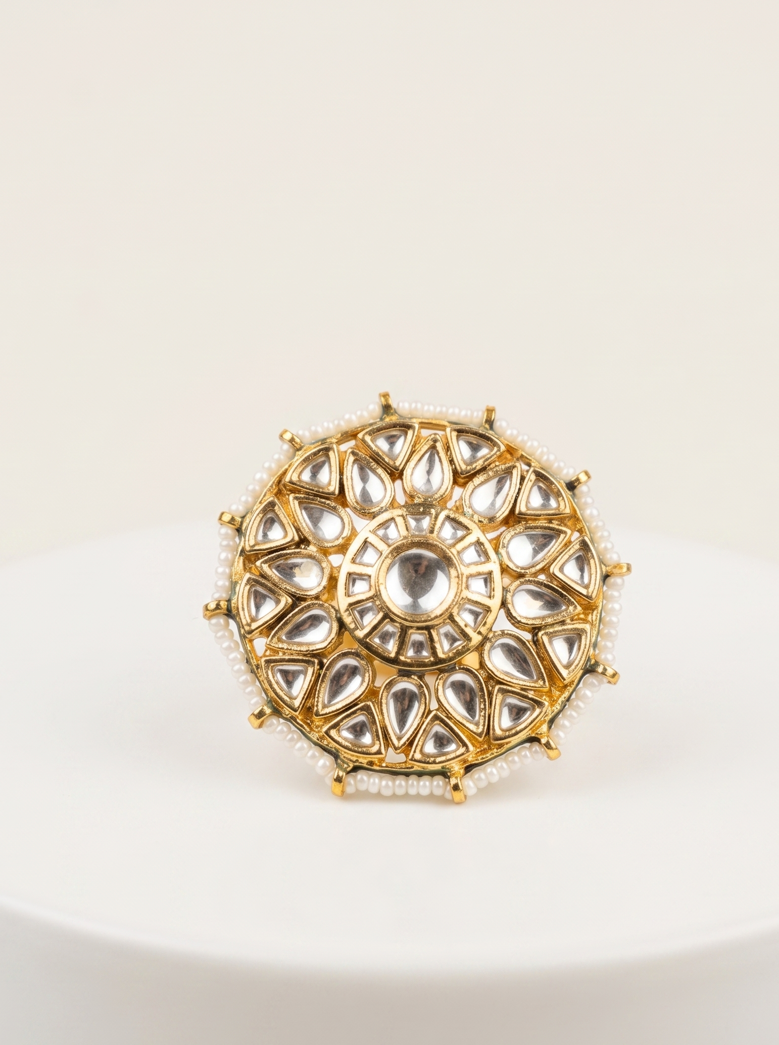 Decorative gold ring with gemstones on a white background