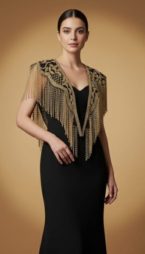 Woman wearing a black evening gown with gold embellishments against a beige background